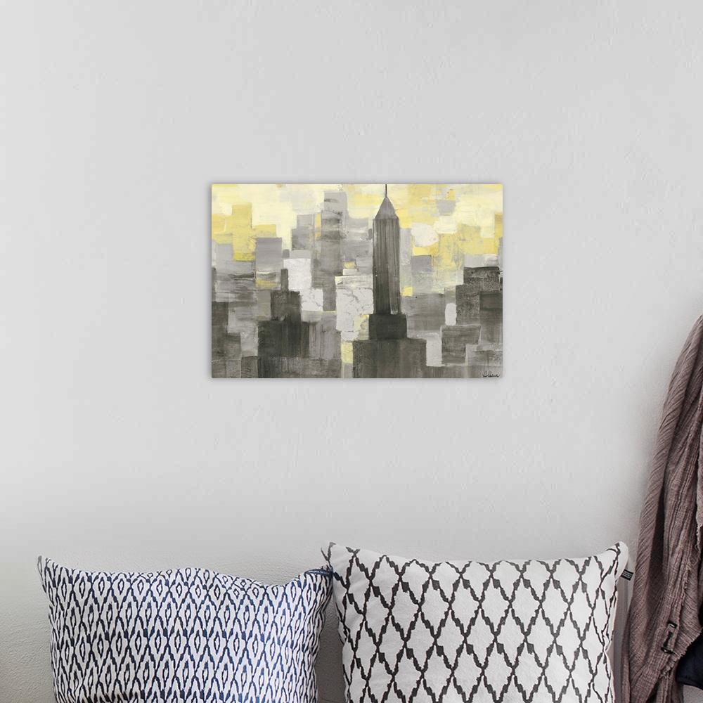 A bohemian room featuring Contemporary artwork of skyscrapers in a city in shades of grey and yellow.