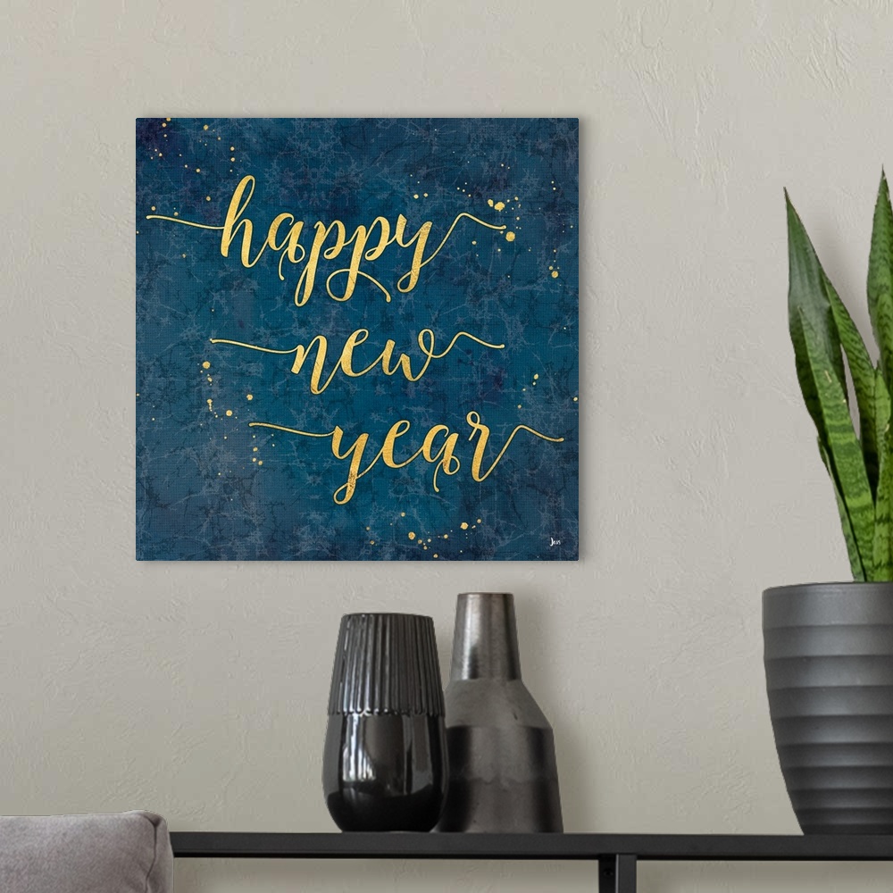 A modern room featuring Decorative square artwork of a marbled blue background with the text "happy new year" in gold wit...