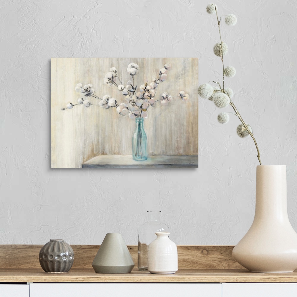 A farmhouse room featuring Still life painting of a cotton bouquet in a glass bottle with a neutral colored background.