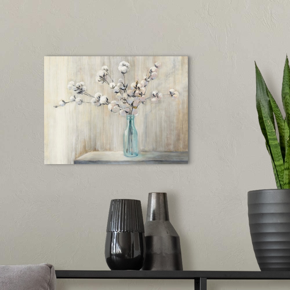 A modern room featuring Still life painting of a cotton bouquet in a glass bottle with a neutral colored background.