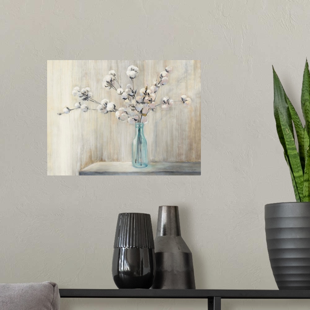 A modern room featuring Still life painting of a cotton bouquet in a glass bottle with a neutral colored background.