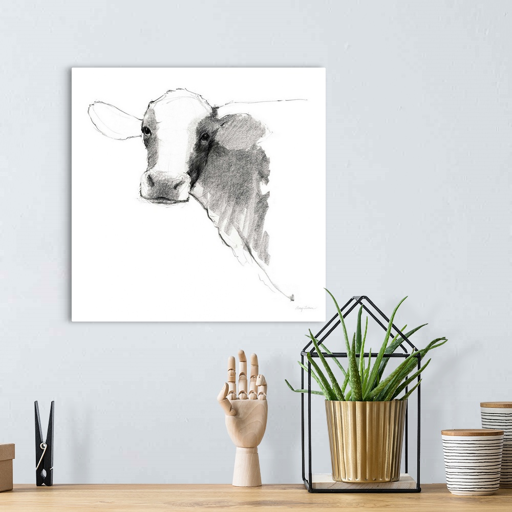 A bohemian room featuring Black and white illustration of a cow on a solid white, square background.
