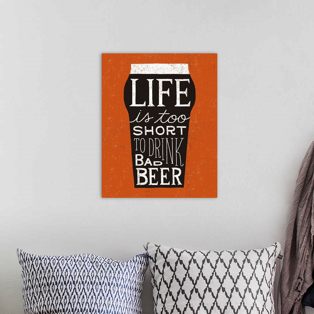 A bohemian room featuring Fun typography artwork in the shape of a beer glass.