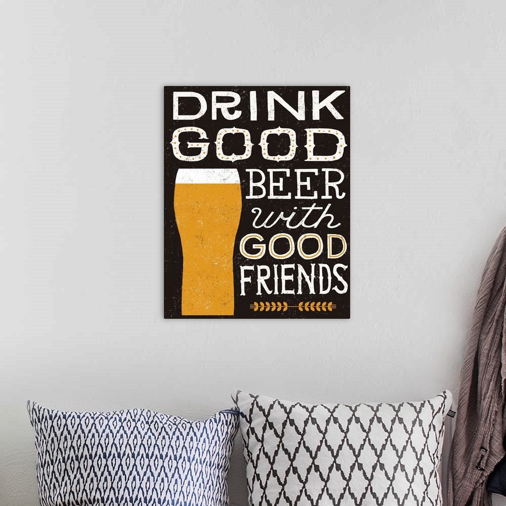 A bohemian room featuring Beer typography artwork on black with a glass.