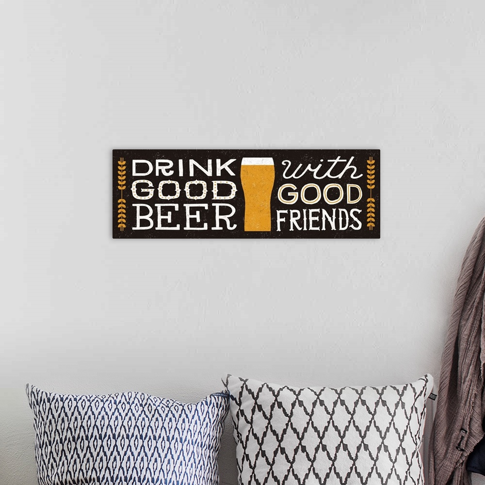 A bohemian room featuring Retro style sign reading "Drink good beer with good friends" with a glass of beer in the center.