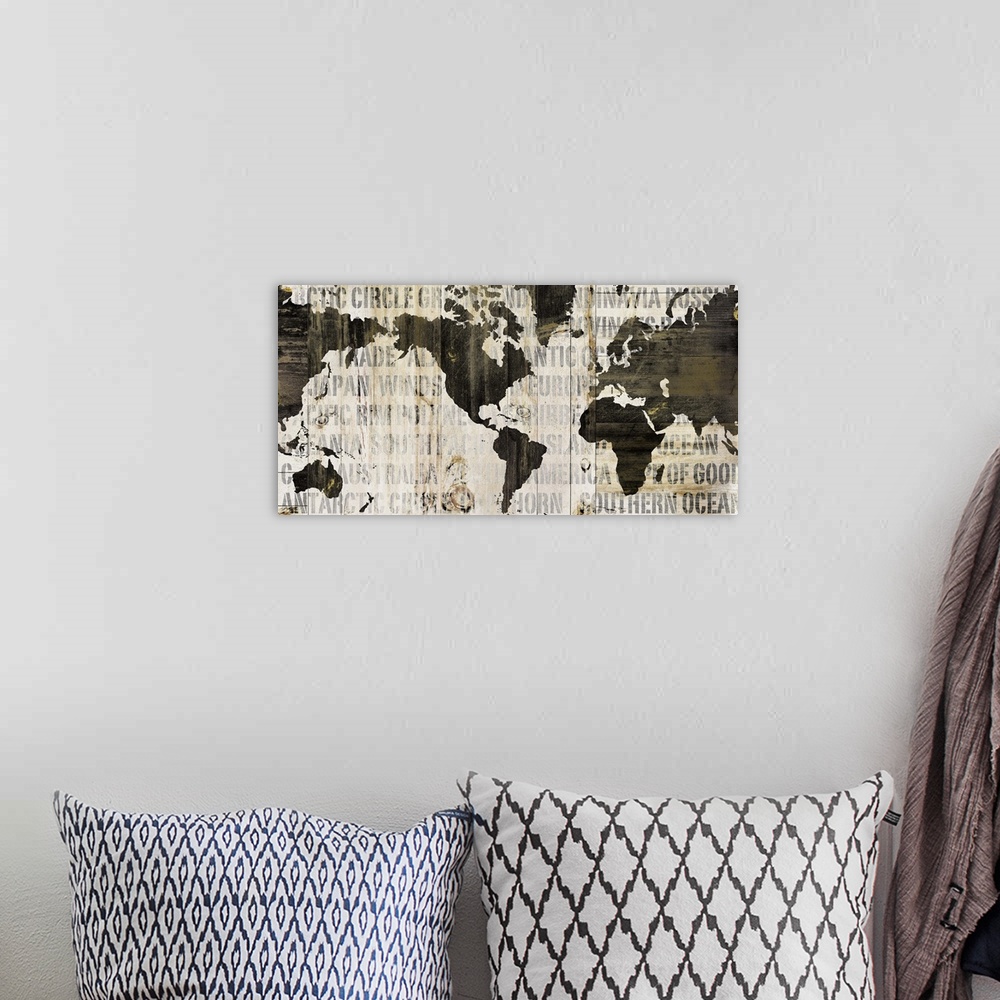 A bohemian room featuring Contemporary artwork of a world map in earth tones and covered in a faded text.