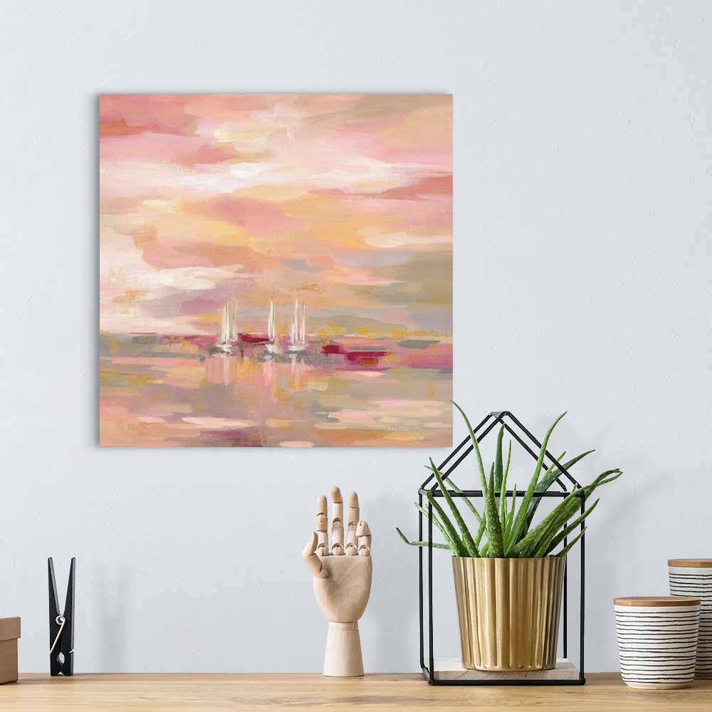 A bohemian room featuring A square painting of sailboats in the ocean in warm shades of pink and yellow.