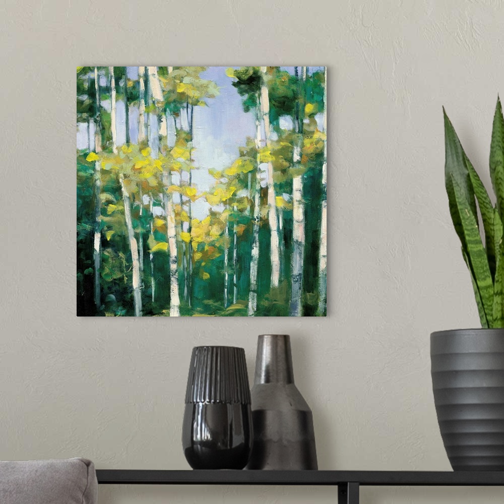 A modern room featuring Contemporary artwork of a forest of birch trees with green leaves.