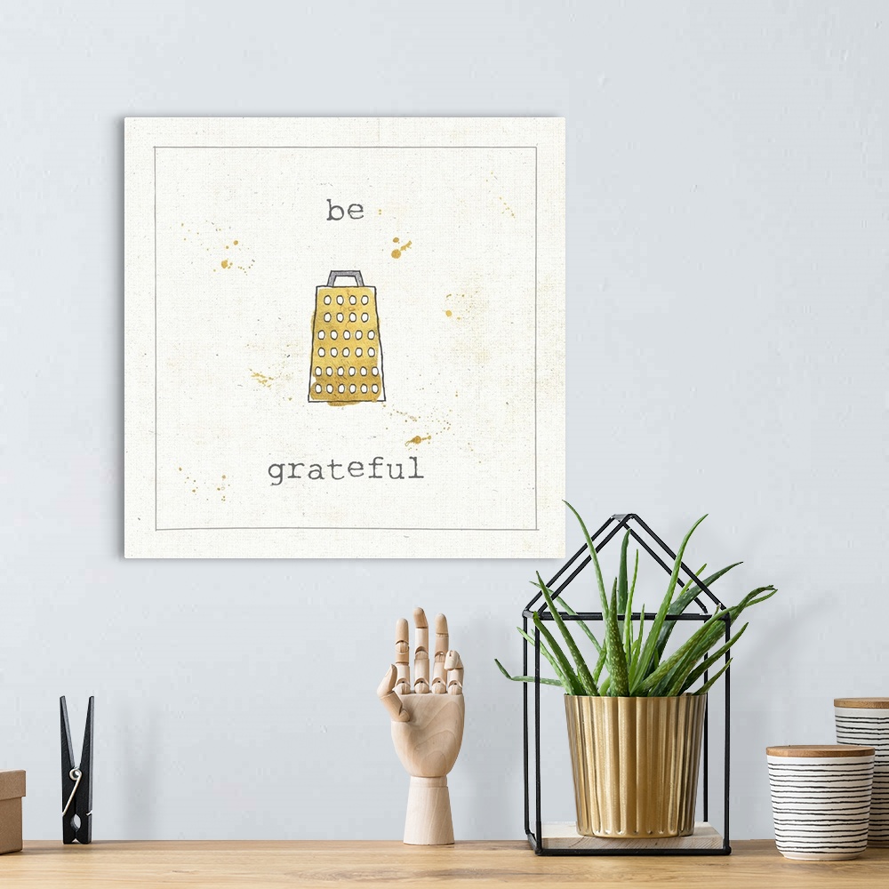 A bohemian room featuring "Be Grateful" pun in metallic gold and silver.