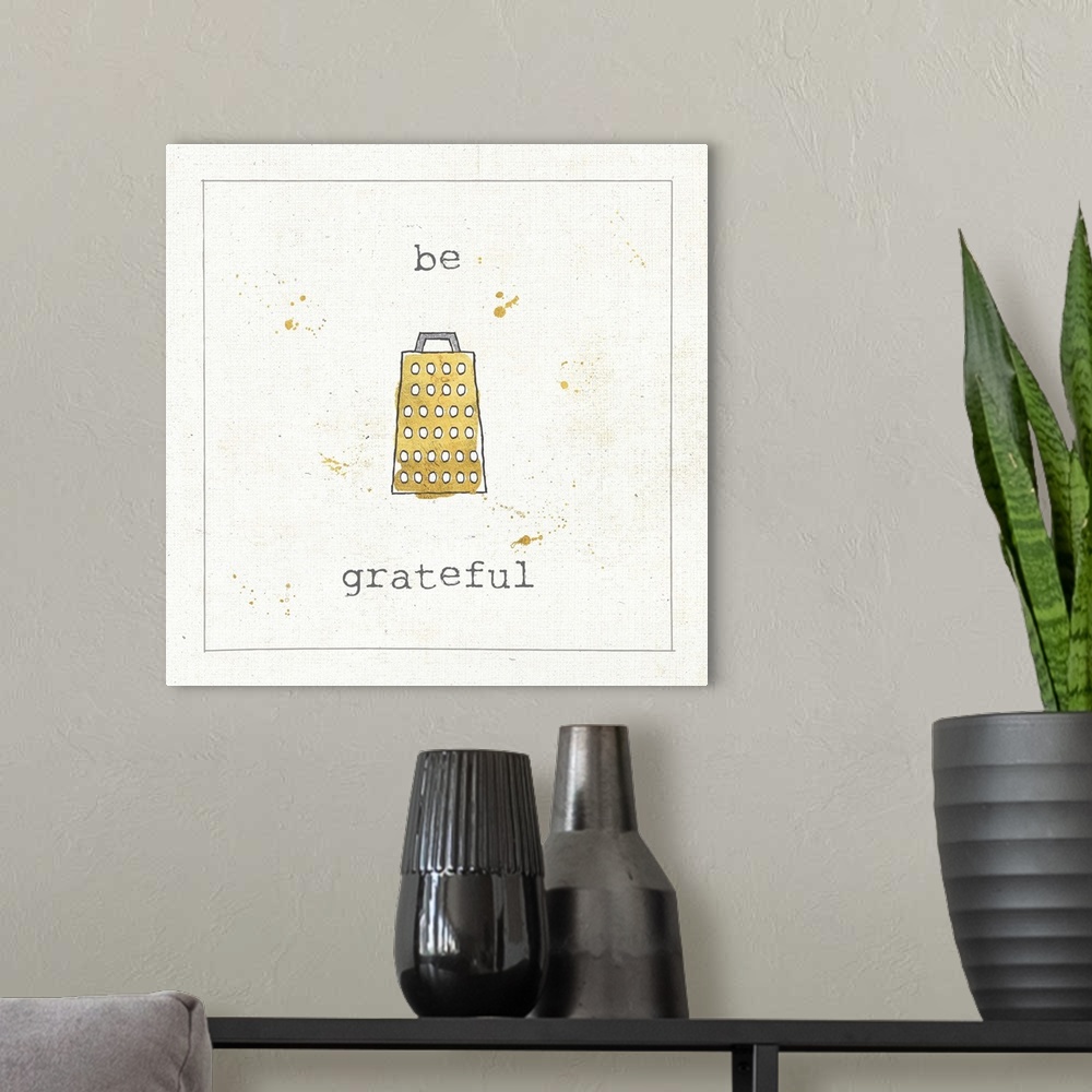A modern room featuring "Be Grateful" pun in metallic gold and silver.