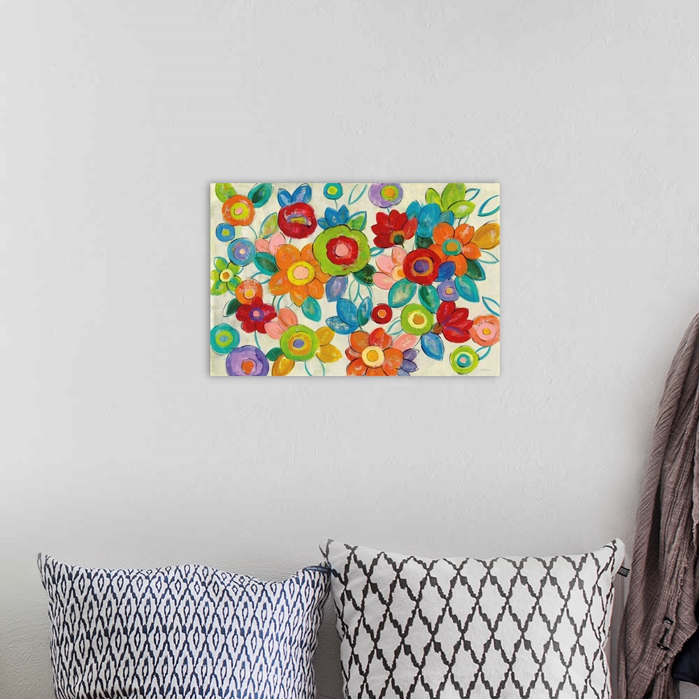 A bohemian room featuring Large abstract painting of bright flowers on a neutral background.
