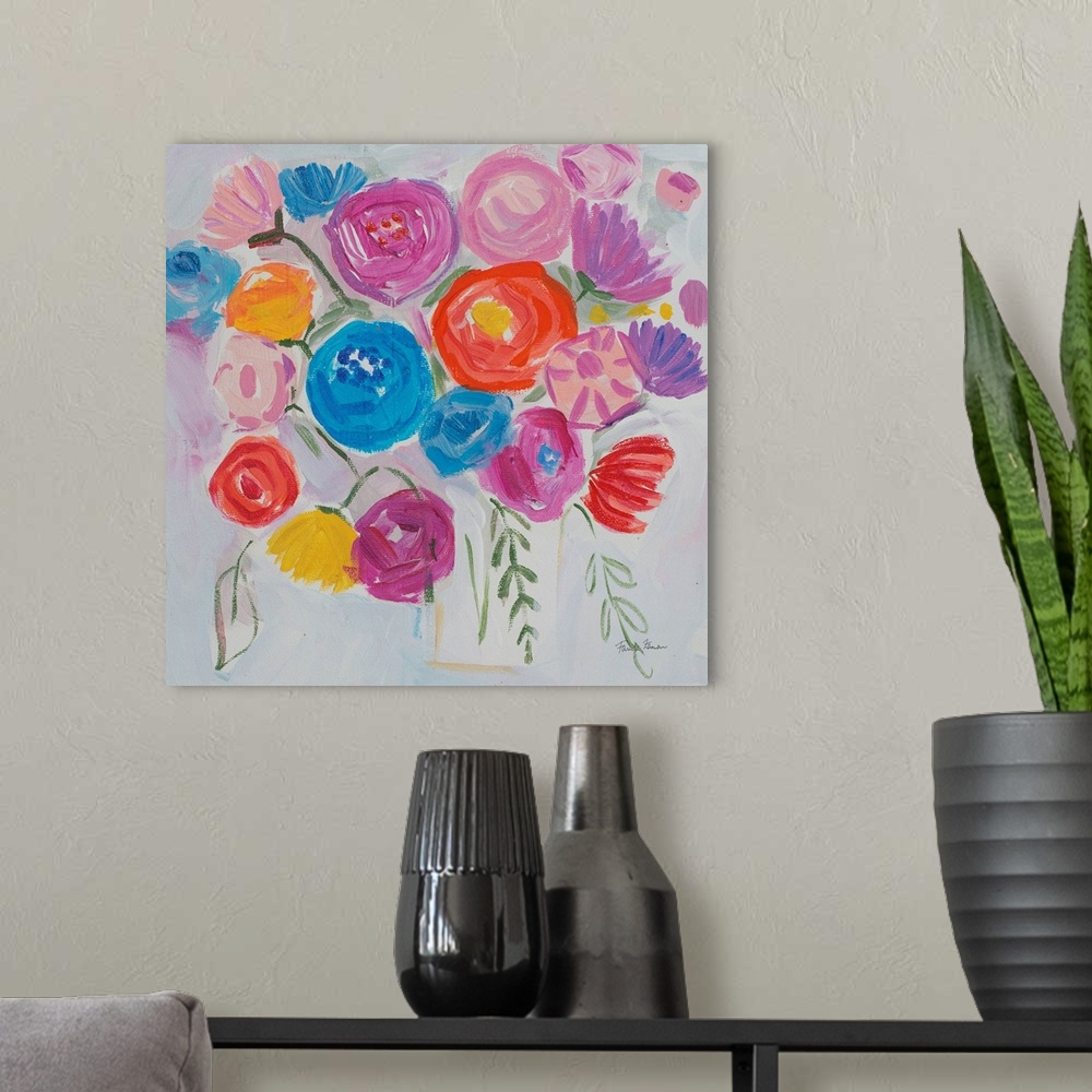 A modern room featuring A square modern painting of bright colorful flowers in in a vase.