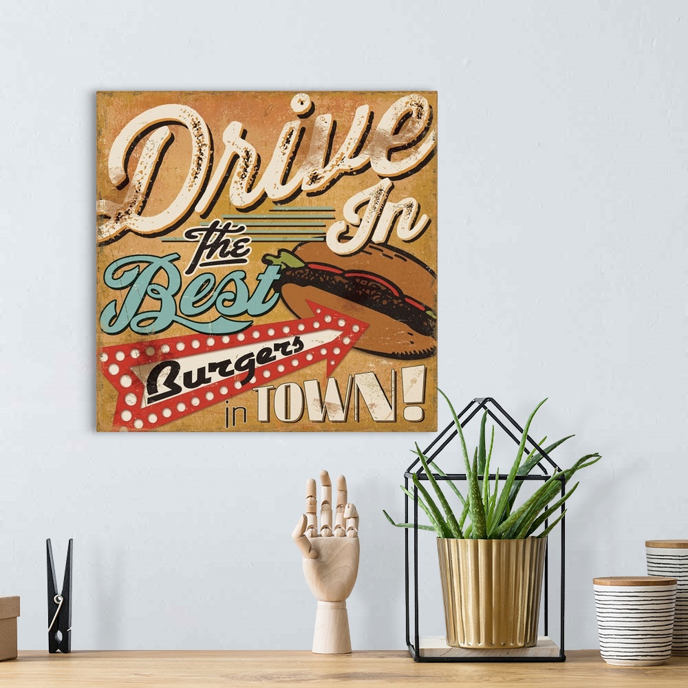 A bohemian room featuring Retro style sign for a drive in, with an arrow pointing to a burger.