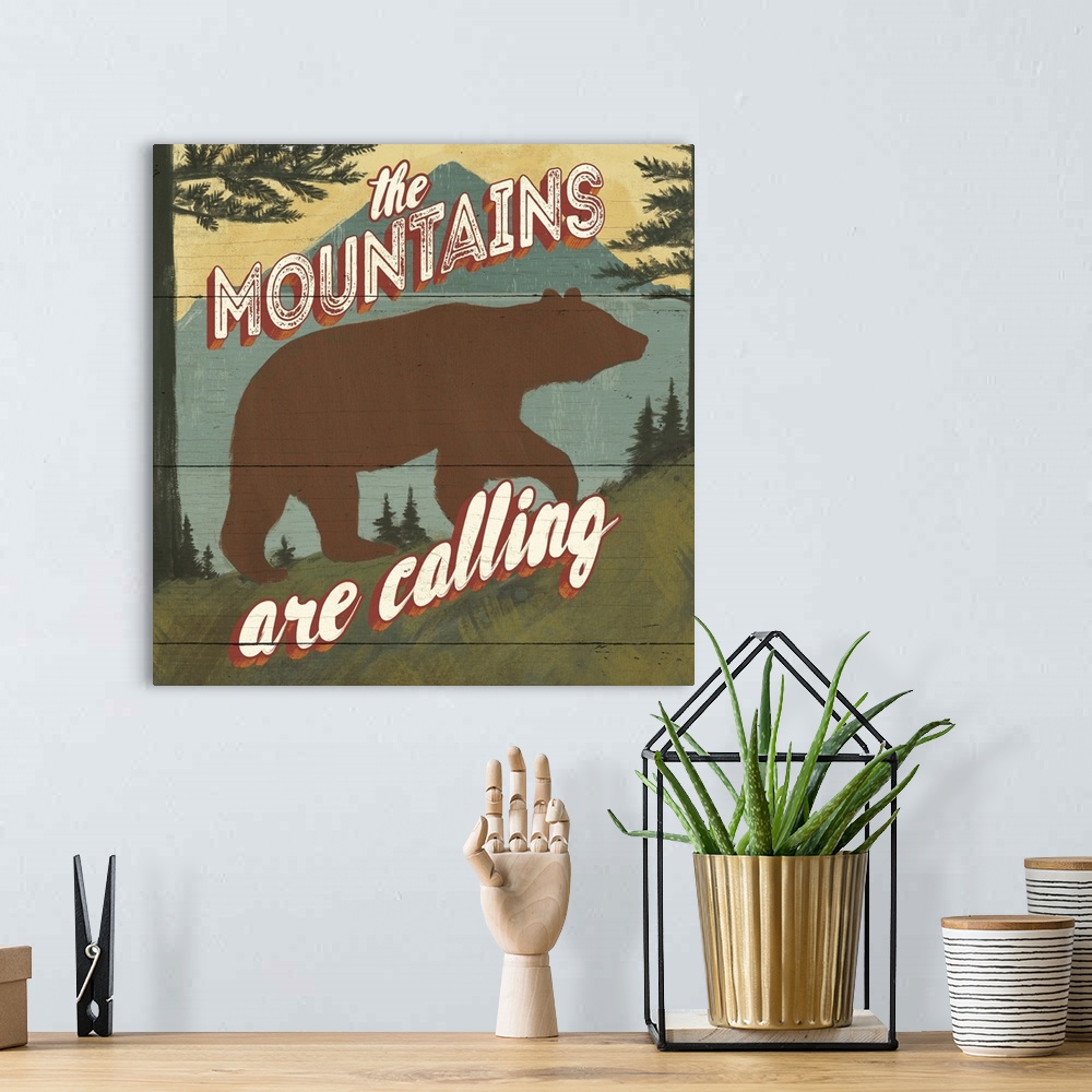 A bohemian room featuring "The mountains are calling" over a minimalist image of a bear in the wilderness.