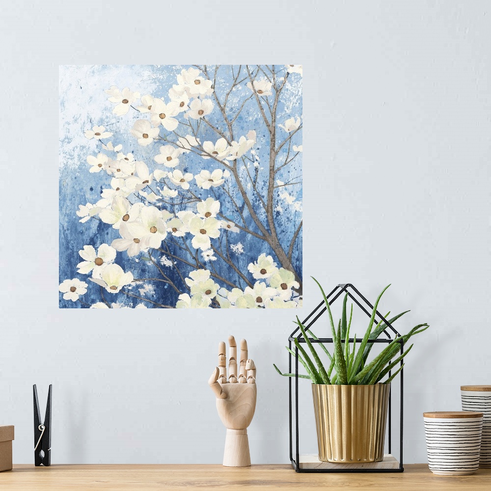 A bohemian room featuring A square temporary painting of a dogwood tree full of blooms with a textures blue background.