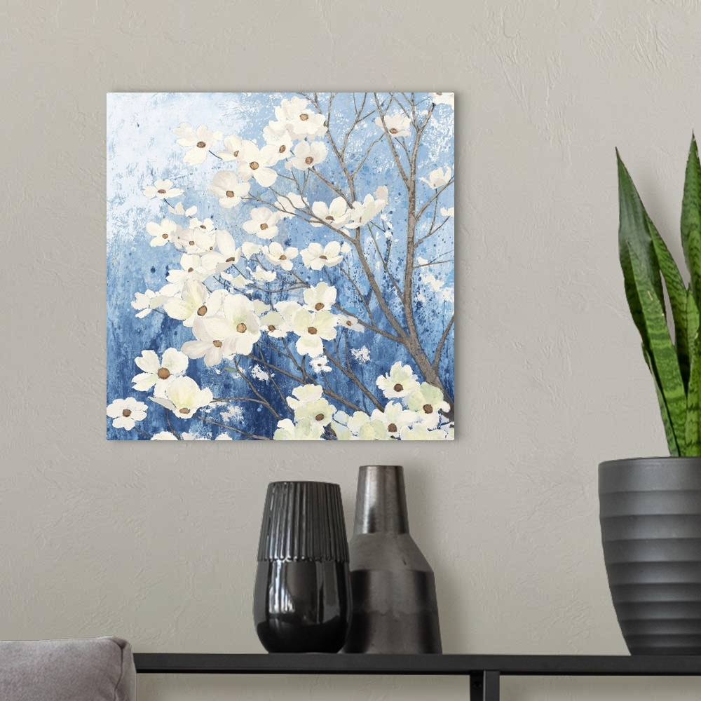 A modern room featuring A square temporary painting of a dogwood tree full of blooms with a textures blue background.