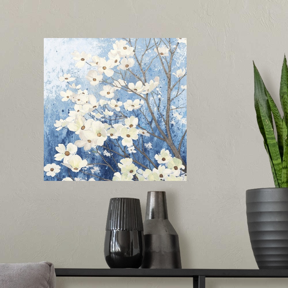 A modern room featuring A square temporary painting of a dogwood tree full of blooms with a textures blue background.