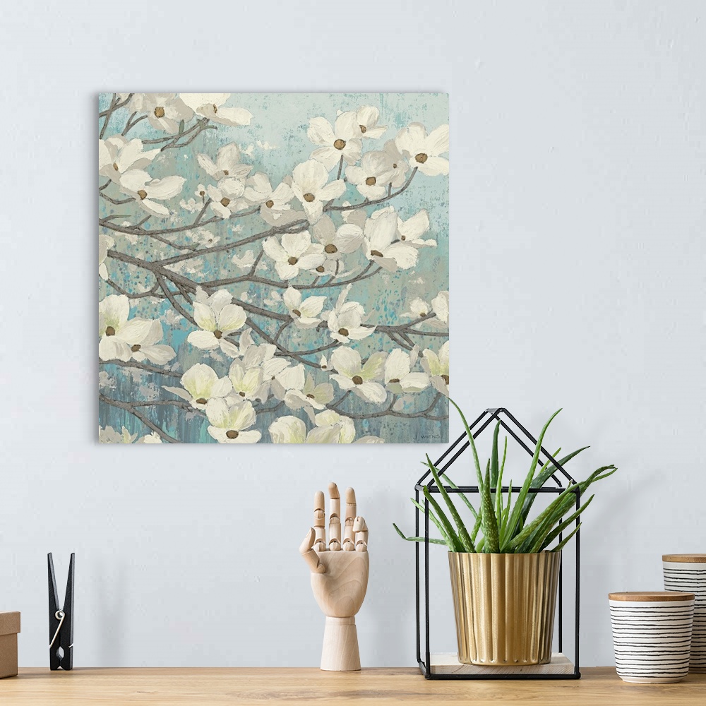 A bohemian room featuring Square painting of a group of small white flowers on thin branches on a light, textured background.