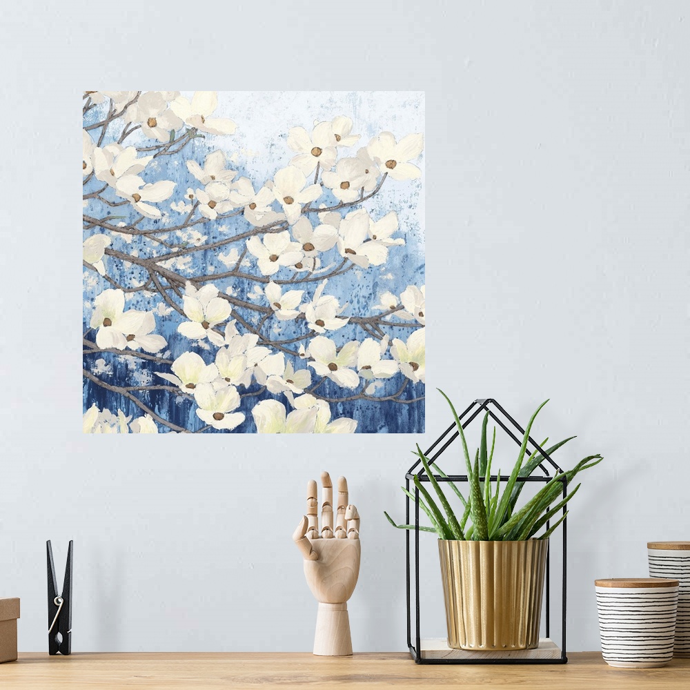A bohemian room featuring A square temporary painting of a dogwood tree full of blooms with a textures blue background.