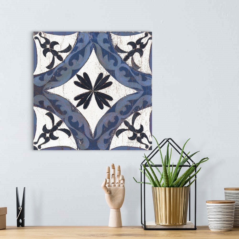 A bohemian room featuring Square abstract painting of a symmetric indigo and white tile-like design.