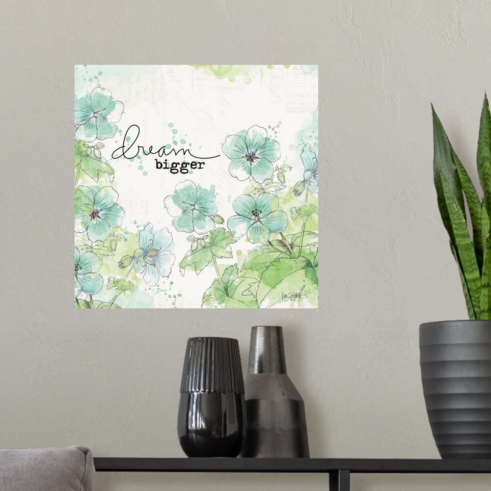 A modern room featuring "Dream Bigger" square art with illustrated blue and green flowers on a  white background with fai...
