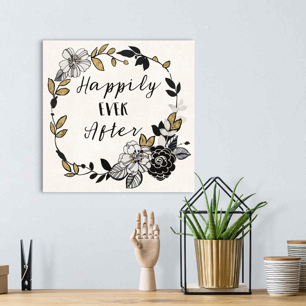A bohemian room featuring "Happily Ever After" written inside a wreath with flowers in black, gold, and silver.