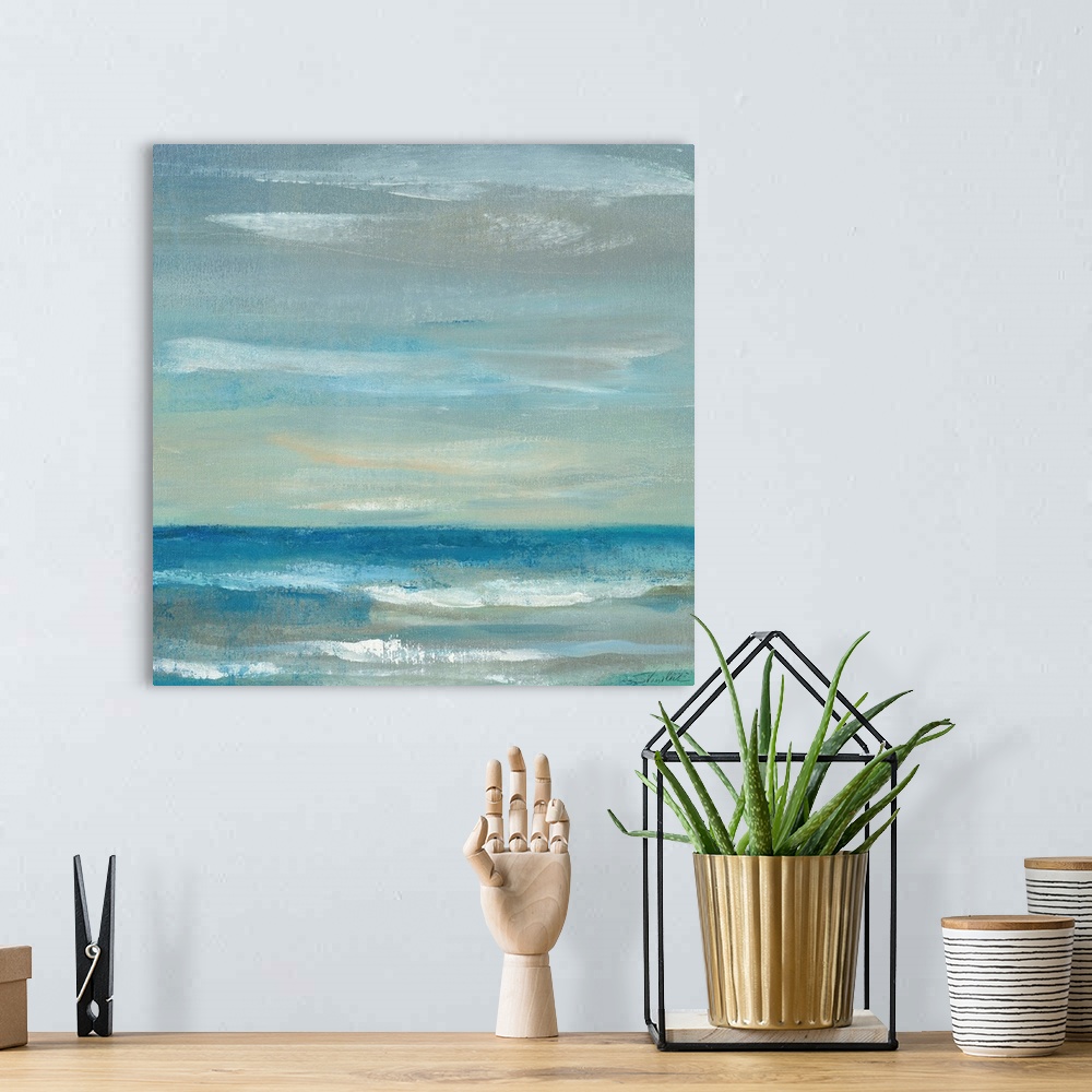 A bohemian room featuring Contemporary artwork of a calm ocean and sky.