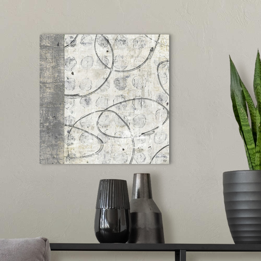 A modern room featuring Big, square home art docor in muted, earth tones of a rock textured background with small circula...