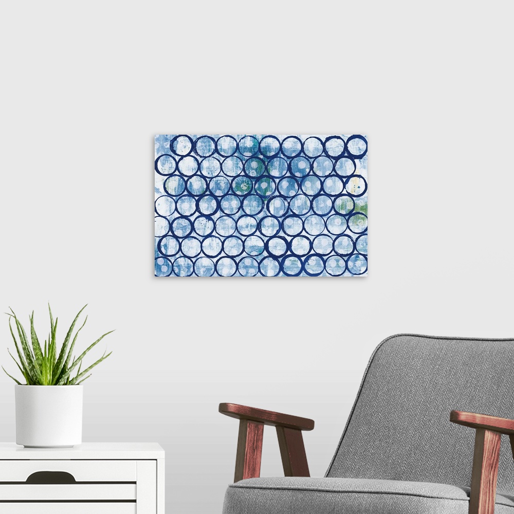 A modern room featuring Large abstract painting of indigo outlines of circles on a blue, green, and white background with...