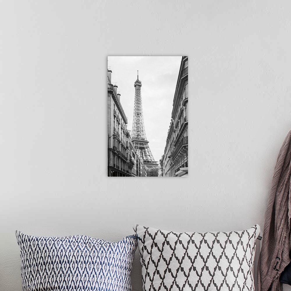 A bohemian room featuring Black and white photograph of the Eiffel tower seen from street level in Paris.