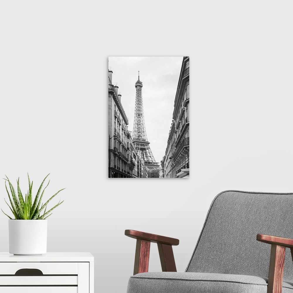 A modern room featuring Black and white photograph of the Eiffel tower seen from street level in Paris.