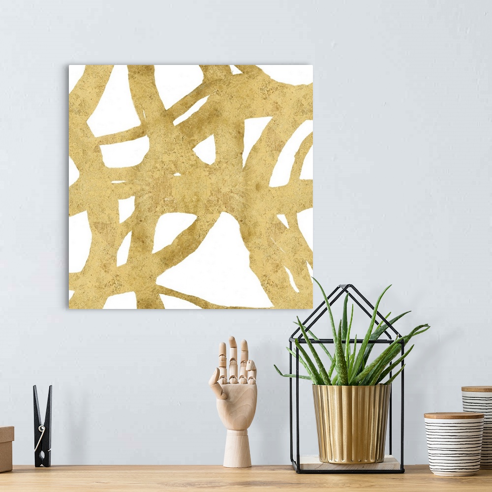 A bohemian room featuring Square abstract art with a gold webbed design on a white background.