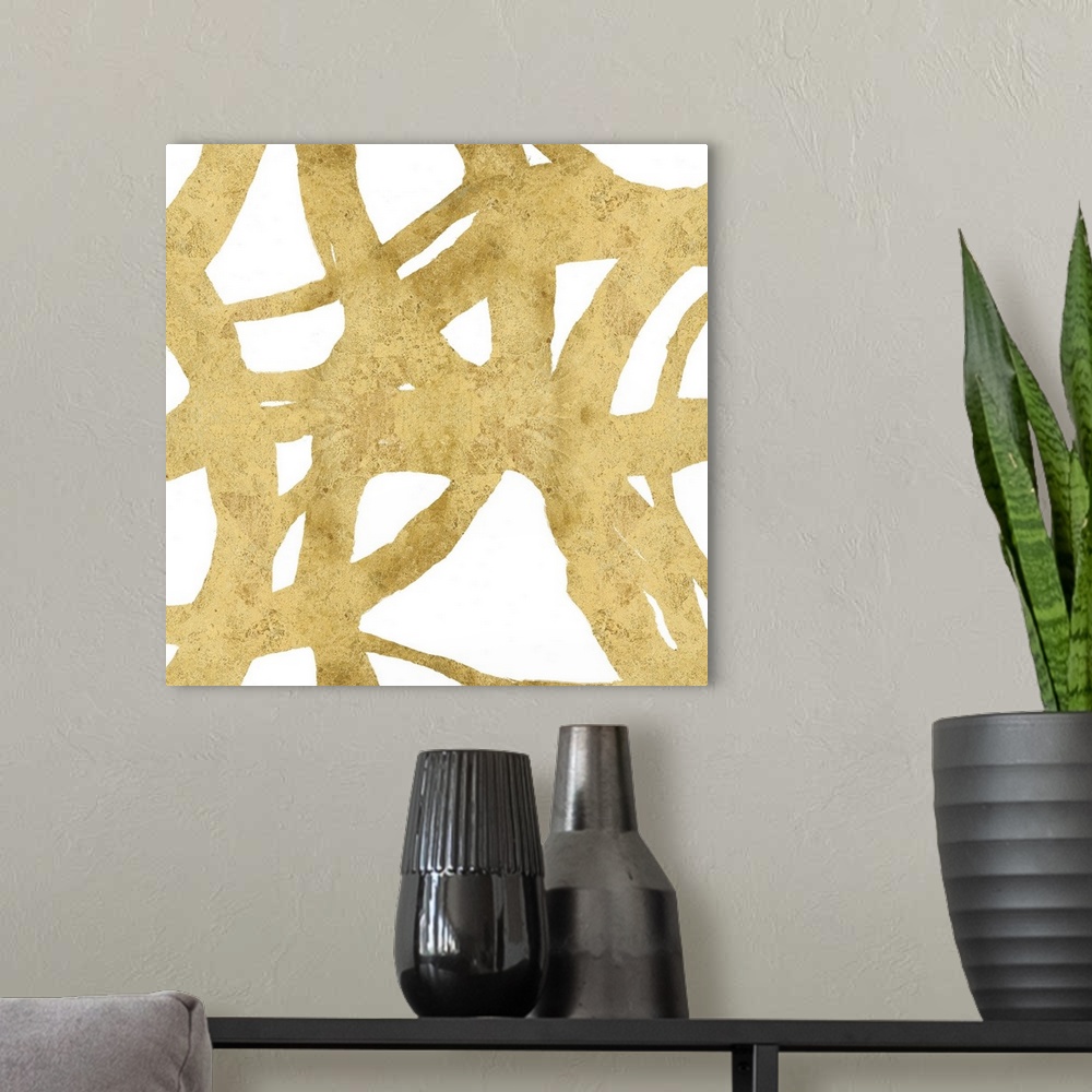 A modern room featuring Square abstract art with a gold webbed design on a white background.