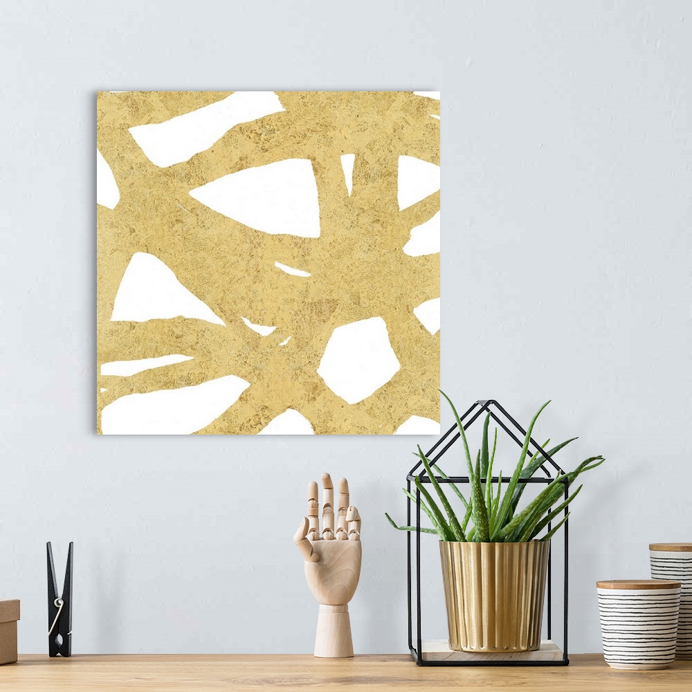 A bohemian room featuring Square abstract art with a gold webbed design on a white background.