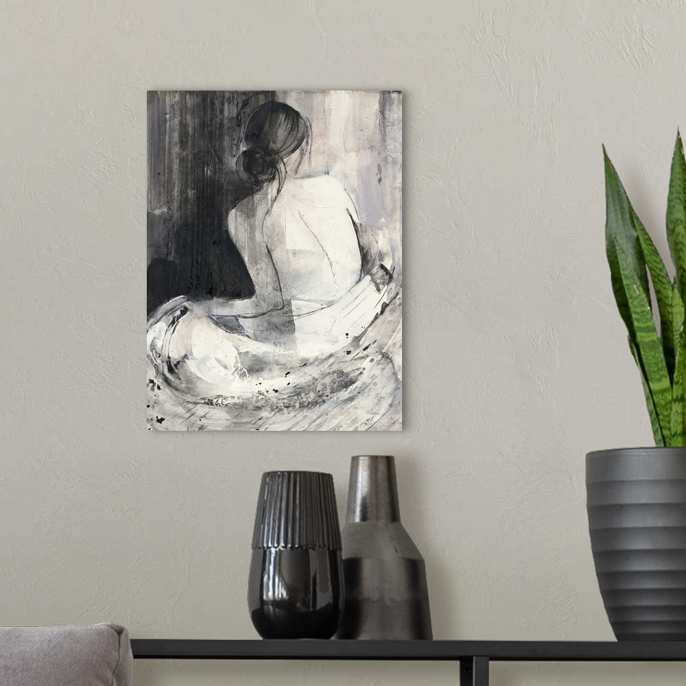 A modern room featuring A painting of the back of a nude woman wrapped in a white cloth done in black and white.