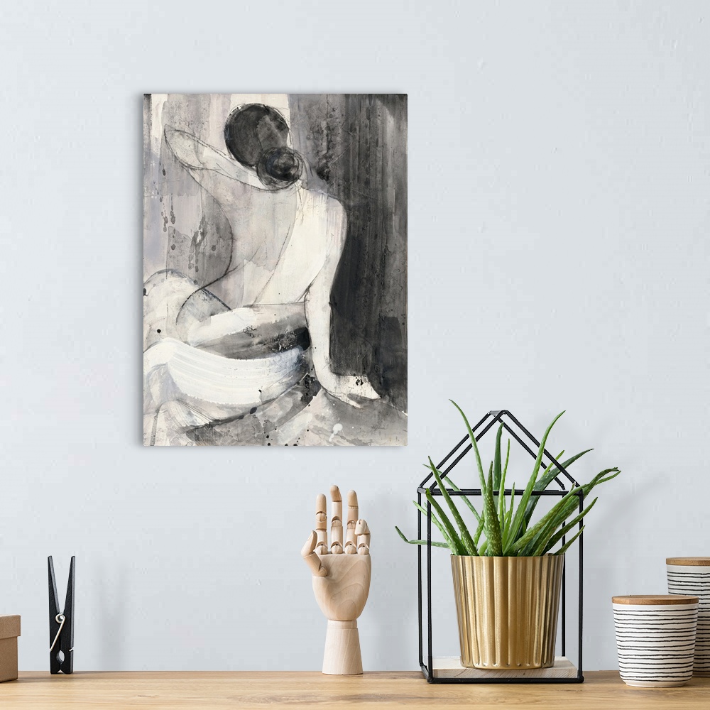 A bohemian room featuring A painting of the back of a nude woman wrapped in a white cloth done in black and white.