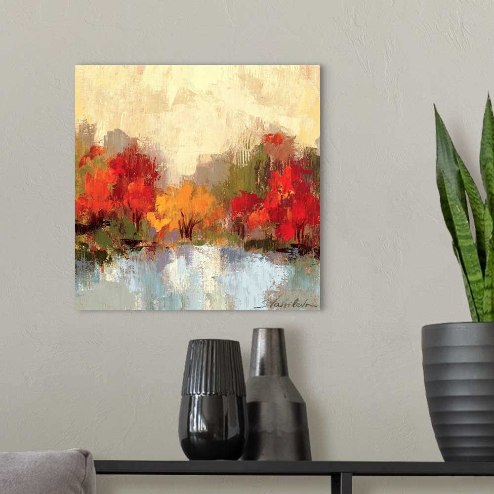 A modern room featuring Large colorful artwork of autumn trees with a cream painted sky and cool toned water in front of ...