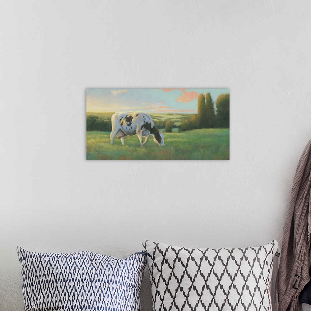 A bohemian room featuring Large contemporary painting of a cow grazing in a field at sunset.