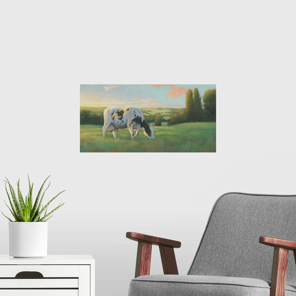 A modern room featuring Large contemporary painting of a cow grazing in a field at sunset.