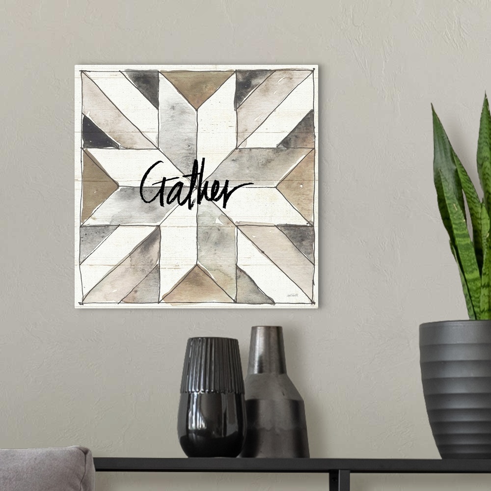 A modern room featuring "Gather" with a watercolor quilt box design in neutral colors on a wood panel backdrop.
