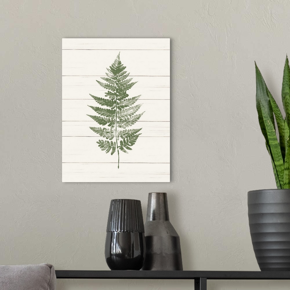 A modern room featuring Decorative artwork featuring stamped green fern against a faux wood background.