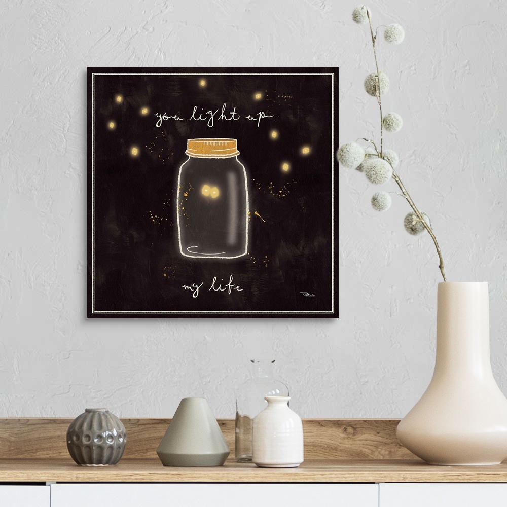 A farmhouse room featuring Decorative artwork of a mason jar with two fireflies inside and the phrase, "You light up my life."