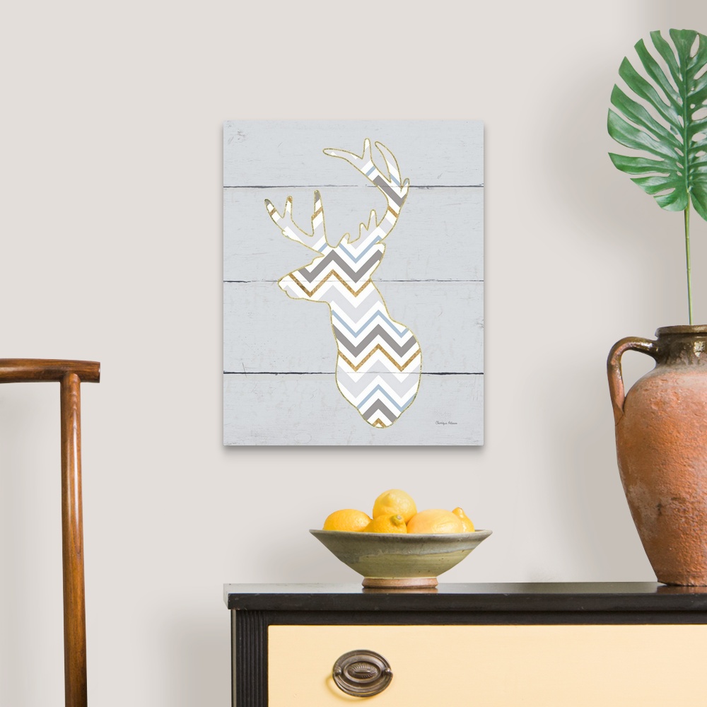 A traditional room featuring A decorative design of a deer silhouette in a chevron pattern and gold accents on a grey wood pan...