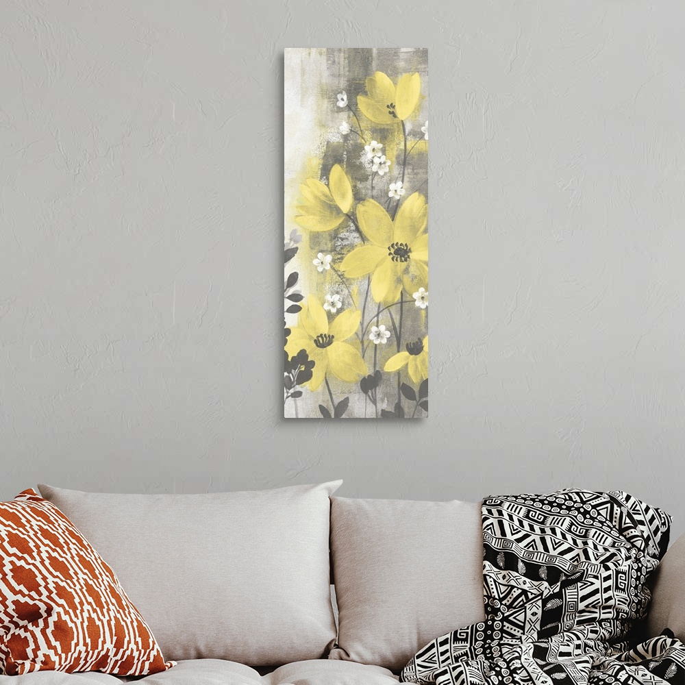 A bohemian room featuring Contemporary artwork of yellow flowers over a distressed gray background.