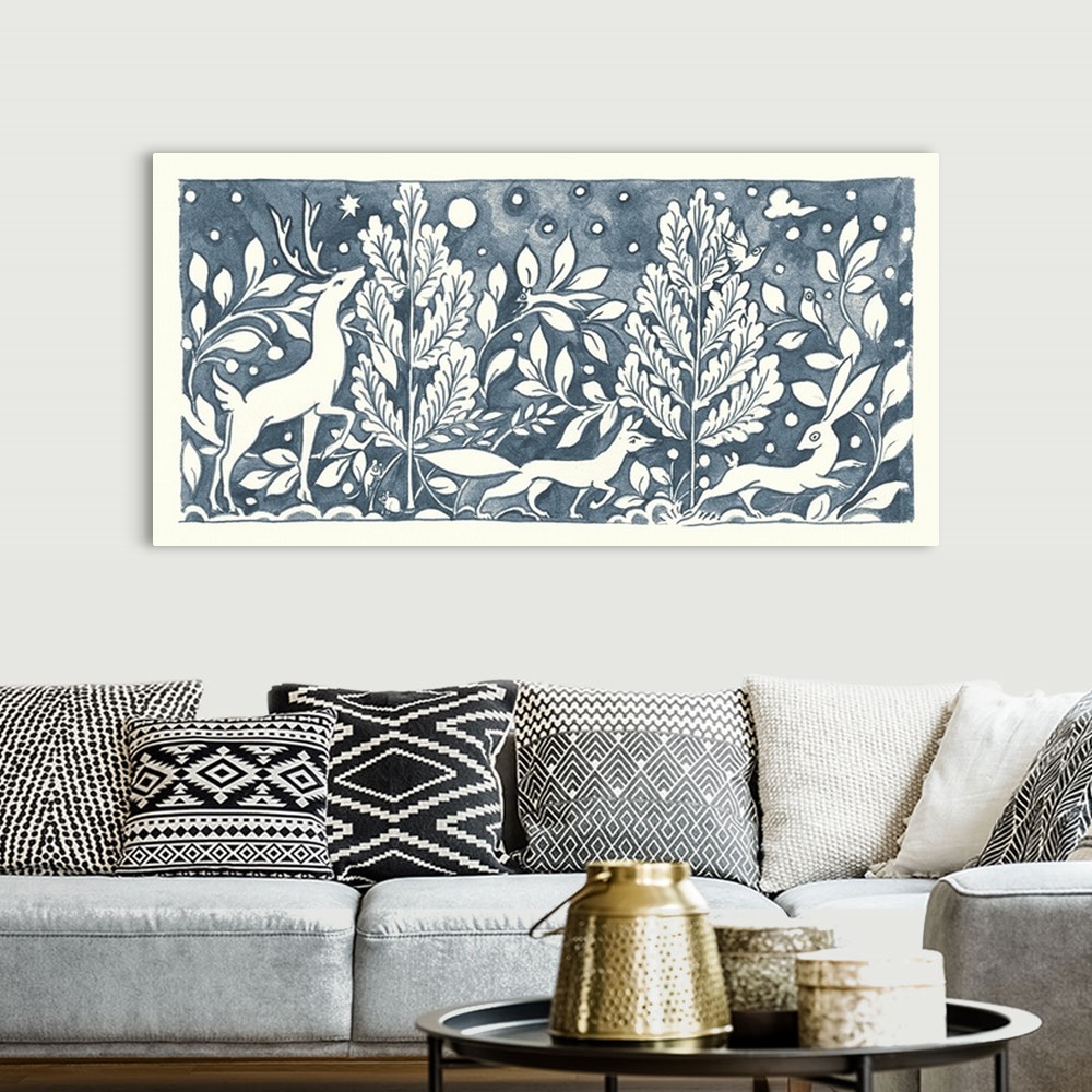 A bohemian room featuring Floral indigo and white watercolor painting with woodland creatures in a wooded scene.