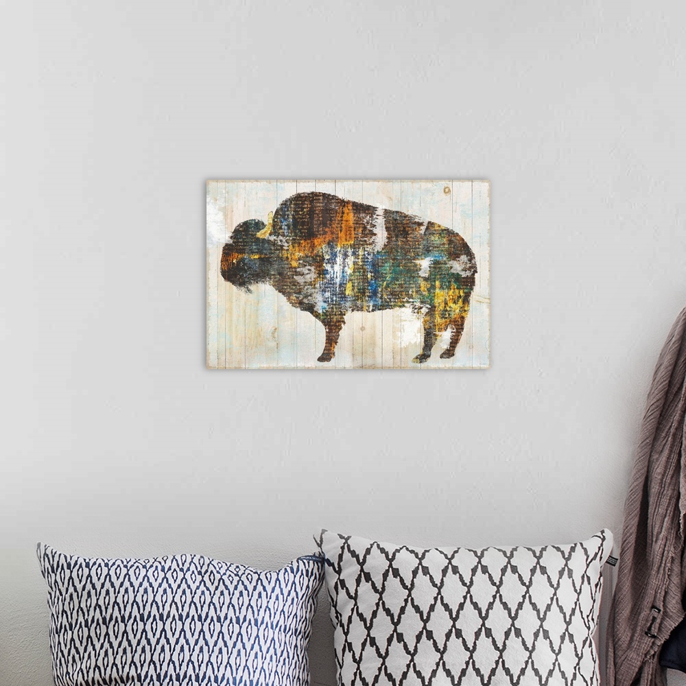 A bohemian room featuring Image of a bison made of multi-color textures with text peeping through, on a wood plank backdrop.