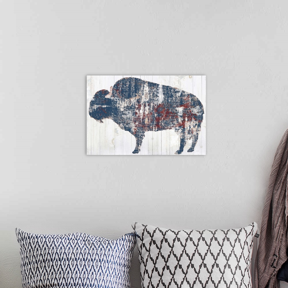A bohemian room featuring Decorative artwork of the silhouette of a buffalo filled with distressed book pages over vertical...