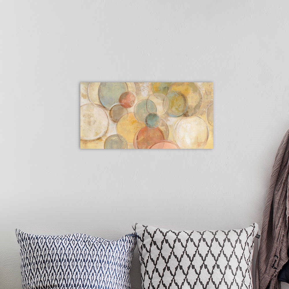 A bohemian room featuring Contemporary abstract painting using circles in various pale tones against a muted yellow backgro...