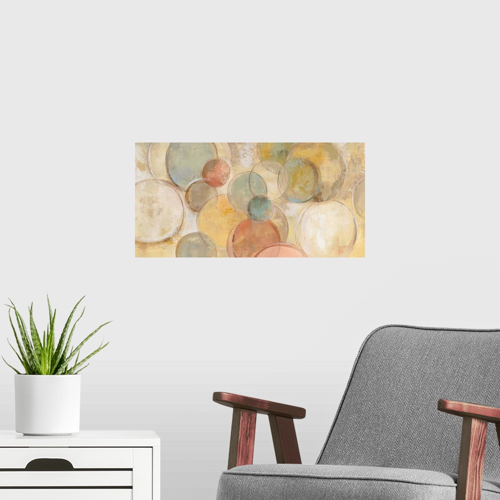 A modern room featuring Contemporary abstract painting using circles in various pale tones against a muted yellow backgro...