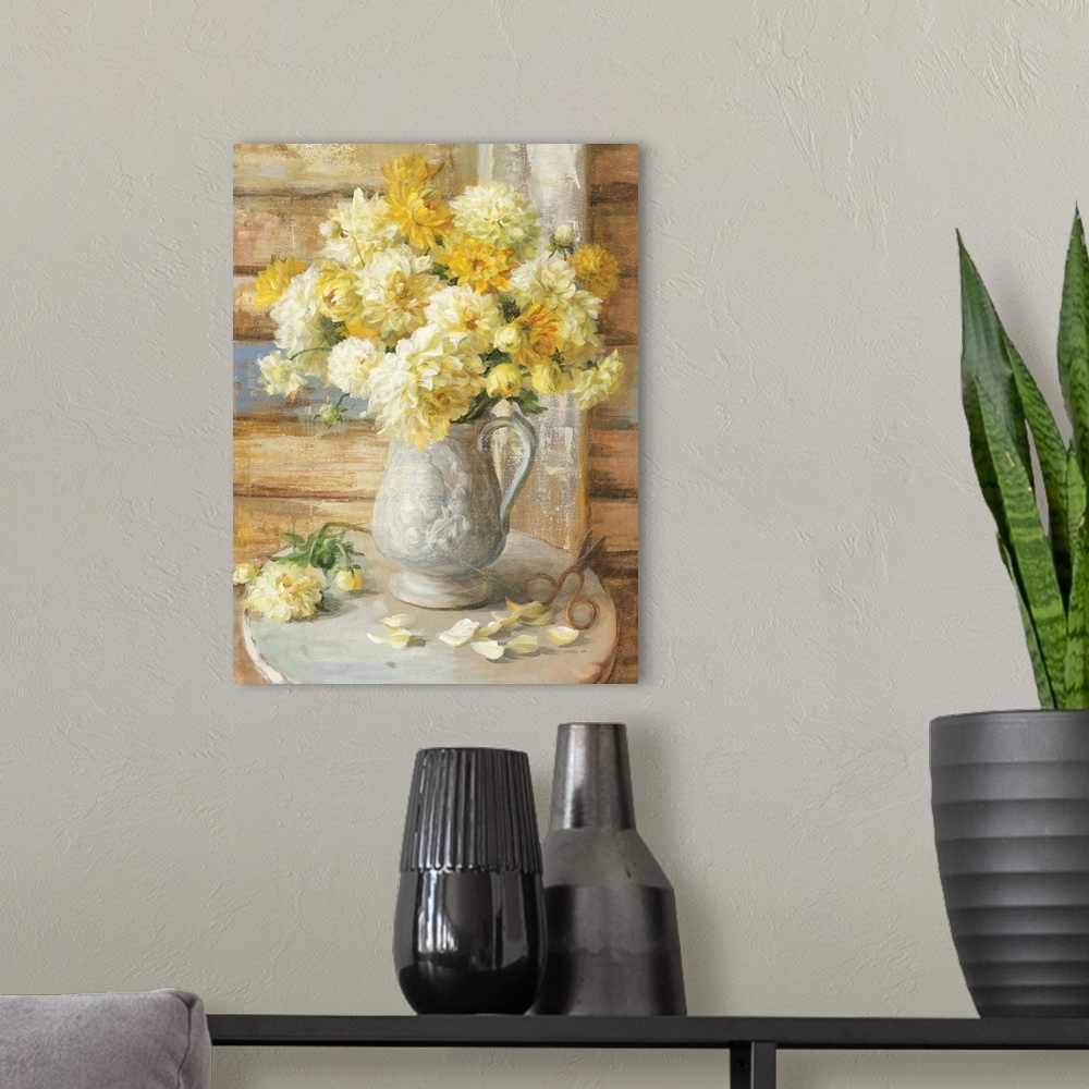 A modern room featuring Contemporary painting of yellow flowers in jug used as a vase sitting on a table.